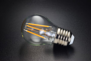 LED filament bulb on black