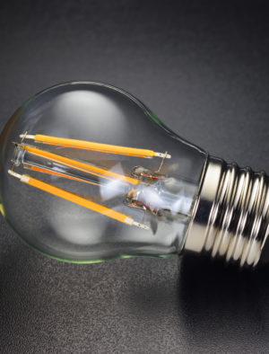 LED filament bulb on black